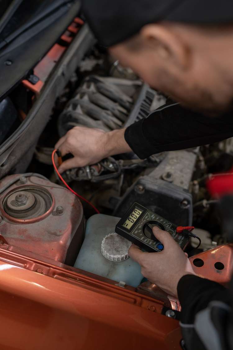 Routine car battery check and replacement service in Dubai